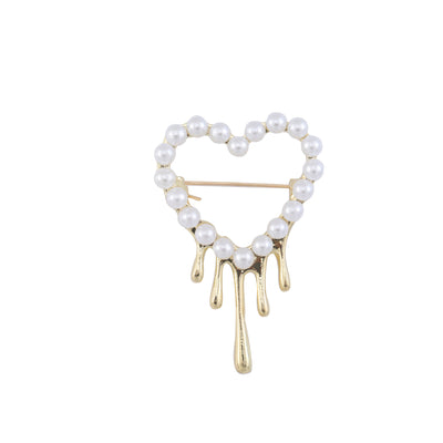 Gold pearl melting heart drip brooch front on white