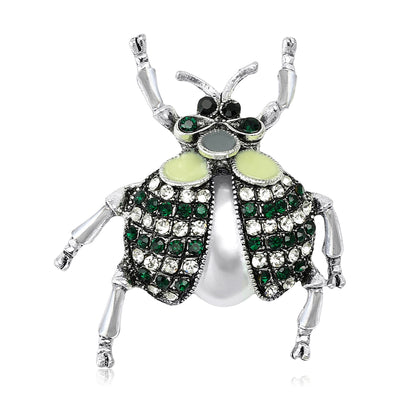 Front view showing the silver tone beetle brooch with green crystal wing details