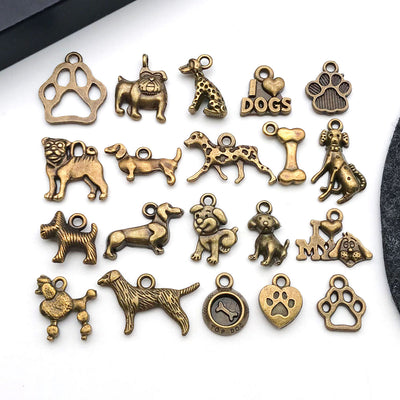 Gold-tone dog charms arranged on a light background