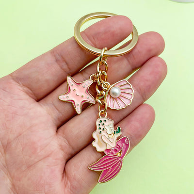 Image 1 showing starfish, conch and shell keychains shown in the product image.