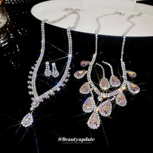 Two Silver Tone Crystal Necklace Earring Sets With Teardrop Designs