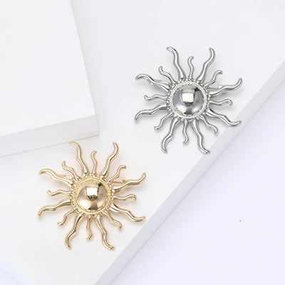 Front view of wavy sun brooch with polished dome center decorative metal pin