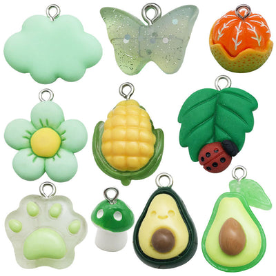 Green butterfly charms arranged on a light background