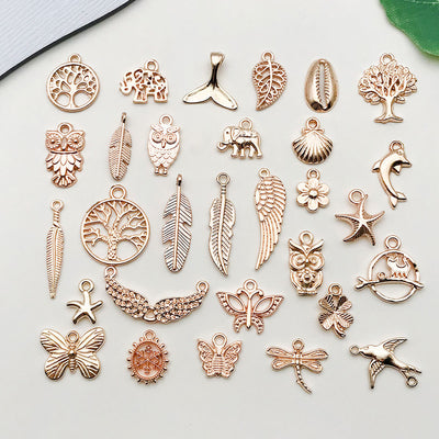 Metallic seashell charms arranged on a light background