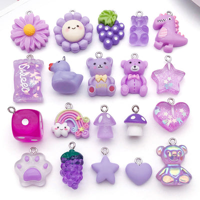 Purple star and heart charms arranged on a light background