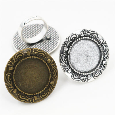 Overview of ornate round adjustable ring settings in antique bronze and silver tones on a light background