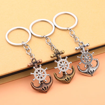 Three anchor keychains in antique copper, antique bronze, and silver-tone finishes arranged side by side.