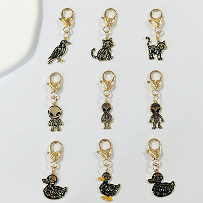 Main product view of gold Tone Gothic Skeleton Cat, Duck and Alien Heart-Clasp Charms