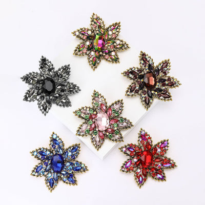 Front view showing the large layered crystal flower brooch in six color variations