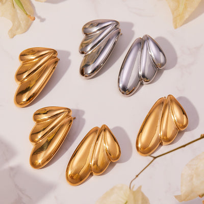 Grouped style view of sculptural triple lobe stud earrings in main image 1.