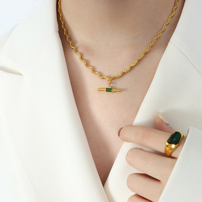 Gold rope chain bar pendant with green glass worn on model
