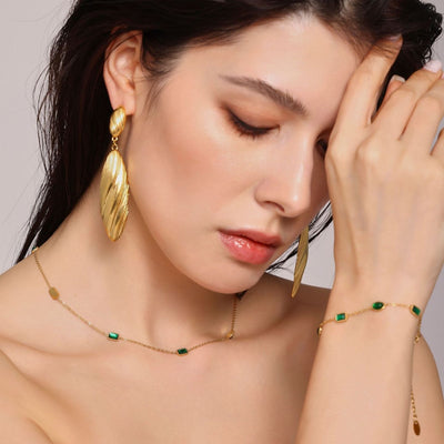 Model wearing gold green zircon station necklace and bracelet
