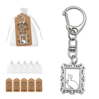 Packaging overview shows the framed rabbit clasp keychain with an organza bag and kraft tags.