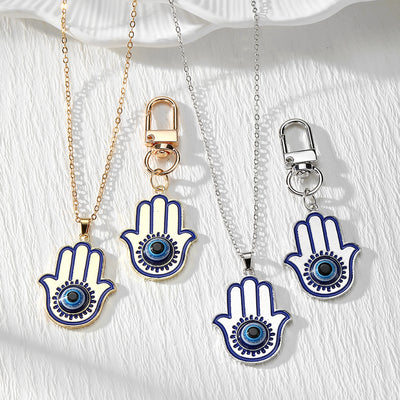 Main product view of blue Evil Eye Hamsa Keychains and Pendant Necklaces in Gold or Silver Tone