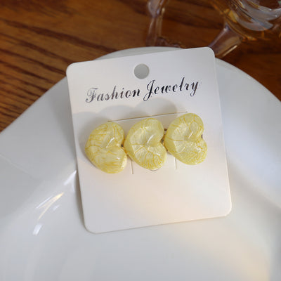 Yellow crackled three-heart hair clip on white Fashion Jewelry card