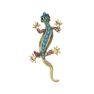 Gold lizard brooch blue pink rhinestones front on white