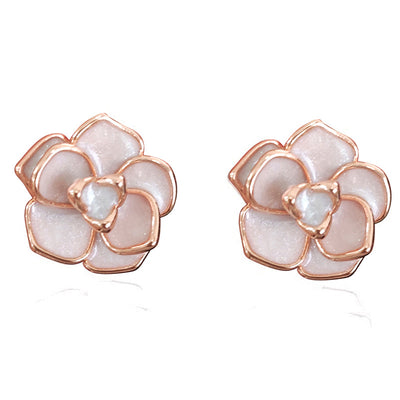 Rose gold white enamel flower stud earrings on white