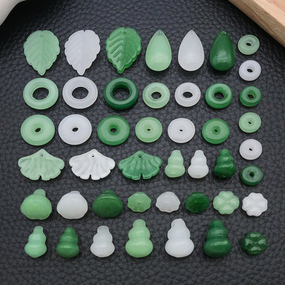 Black assorted shape charms arranged on a light background