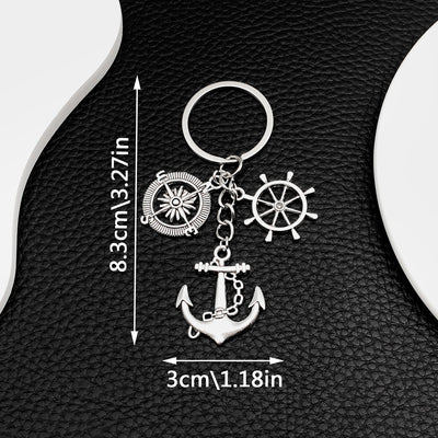 Front product photo of antique silver anchor ship wheel and compass nautical charm keychain showing the pictured design