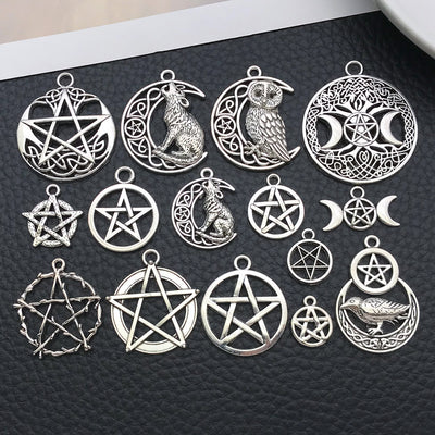 Antique silver star charms arranged on a light background