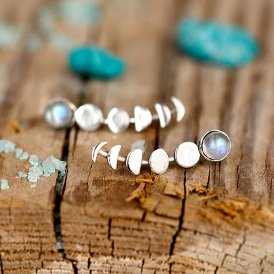 Silver moon phase ear climber studs with cabochons on weathered wood