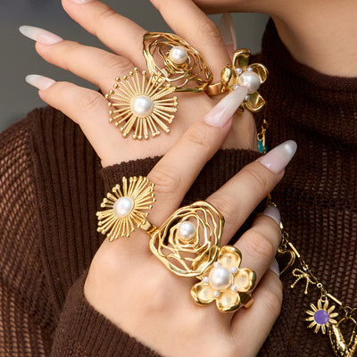 Styled hand view of pearl flower statement rings in main image 1.