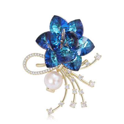 Front view of layered Blue Crystal Flower Brooch With Pearl and Spray Stems against a white background.