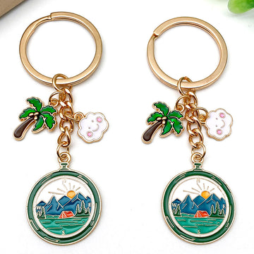 Four Green Camping Mountain and Palm Tree Metal Keychain Designs