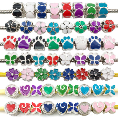 Colorful heart and butterfly beads arranged on a light background
