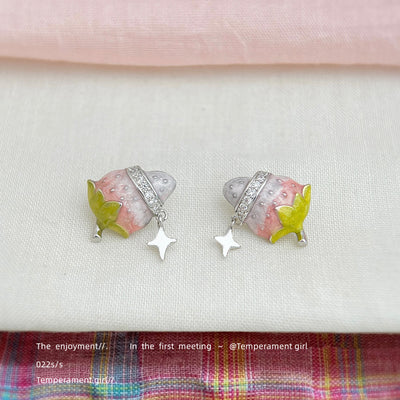 Pink enamel strawberry star drop studs on white cloth