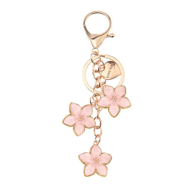 Gold keychain with three pink enamel blossoms and a lobster clasp