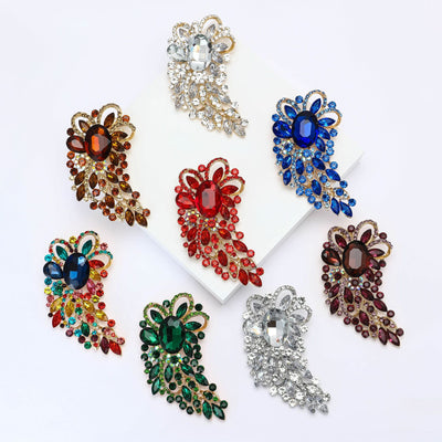 Front view of an oversized paisley plume densely set with colorful faceted stones