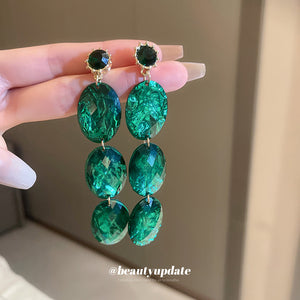 Emerald Green Oval Crystal Drop Earrings With Polished Metal Tone Details