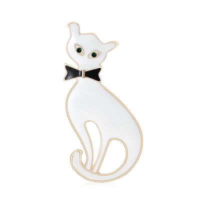 White enamel cat brooch black bowtie green eyes front