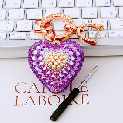 Main image 1 shows a supplied presentation of pearl heart keychains with visible attached key hardware.
