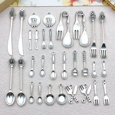 Antique silver assorted shape charms arranged on a light background