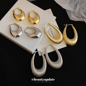 Textured and Polished Oval Hoop Earrings in Gold and Silver