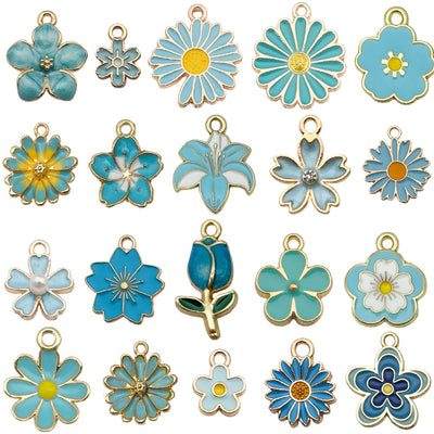 Colorful sunflower and cherry blossom charms arranged on a light background