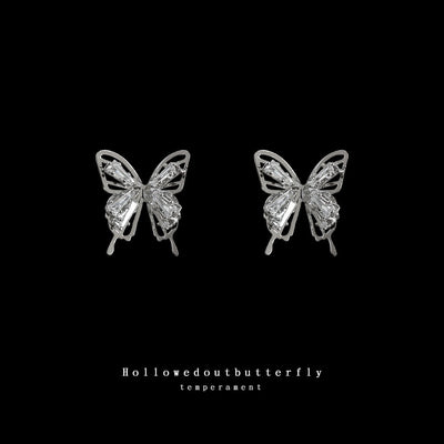 Silver crystal hollow butterfly studs on black background