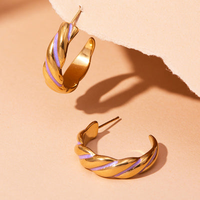 Display view of twisted plain blue purple enamel hoop earrings in main image 1.