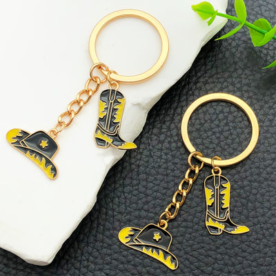 Overview showing the available color and design variations of the black gold western hat and boot star metal keychain