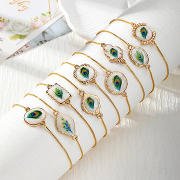 Gold Tone Peacock Feather Evil Eye Slider Bracelets in Nine Shapes