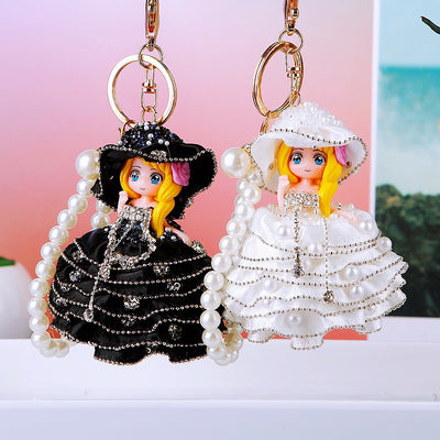 Main image 1 shows a supplied presentation of pearl ballgown doll keychains with visible attached key hardware.