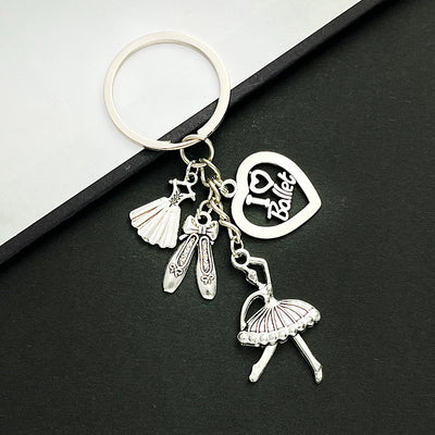Front product photo of antique silver ballerina dress shoe and heart charm keychain showing the pictured design arrangem