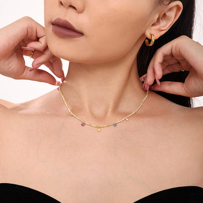 Beige natural stone bead choker with multicolor zircon charms on model