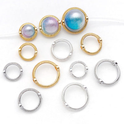 Silver-tone bead frame charms arranged on a light background