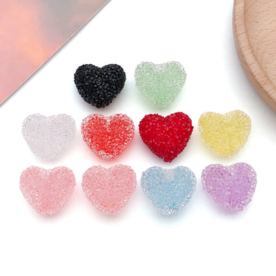 Red heart charms arranged on a light background