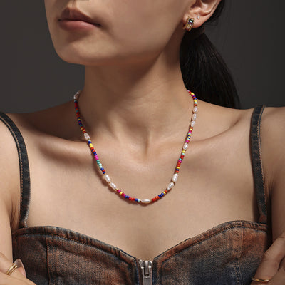 Colorful seed bead pearl necklace worn at collarbone
