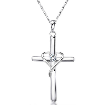 Product view showing heart-wrapped cross pendant necklace in two metal tones