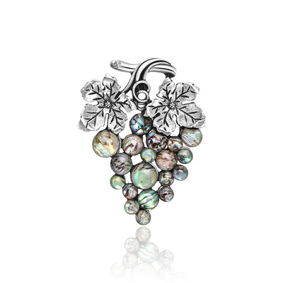 Front view of grape cluster formed from iridescent round inlays beneath textured leaves